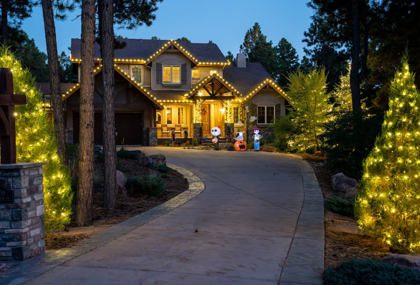 Large home with warm seasonal holiday lighting