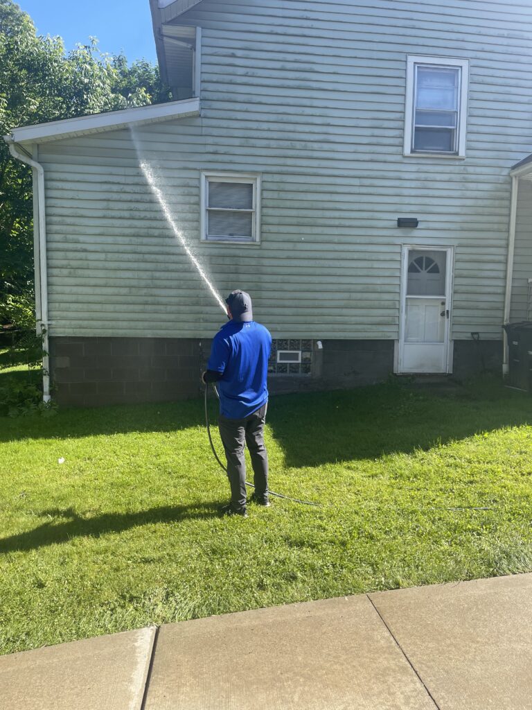 Rubber City Power Wash technician soft washing a home in Akron Ohio